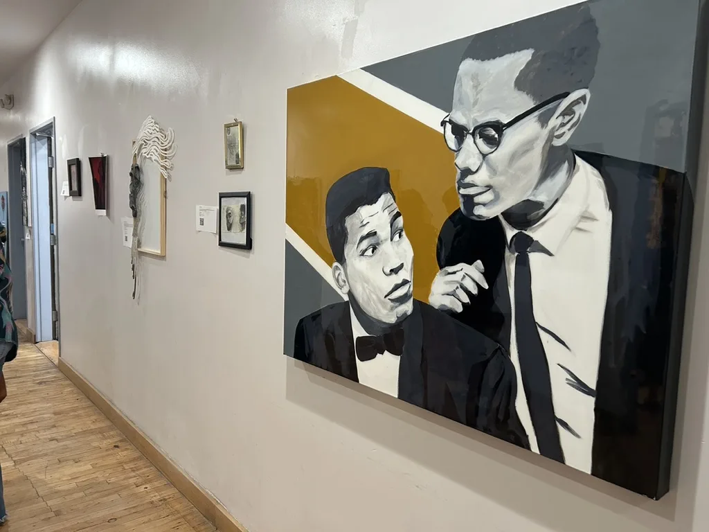 Painting of Muhammad Ali and Malcolm X installed on a gallery wall
