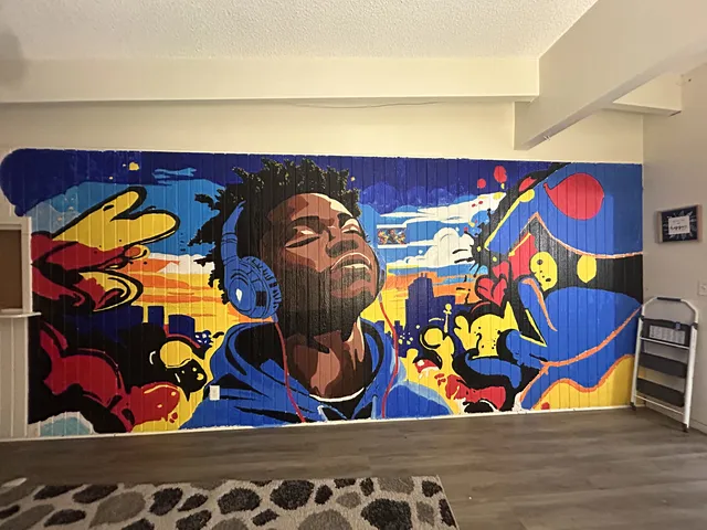 Banning mural of a young man's face among bold blue, yellow and red shapes
