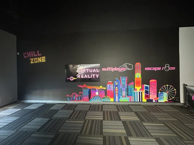 Neon city skyline mural across a dark Chino arcade wall