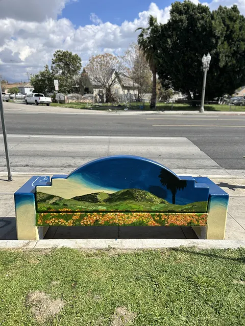 Colton bench painted with palm trees against a sunset