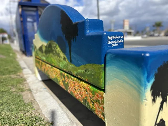 The Colton bench painted with green hills and wildflowers