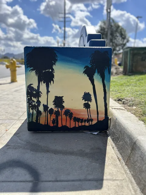 End of the Colton bench painted with palms at dusk