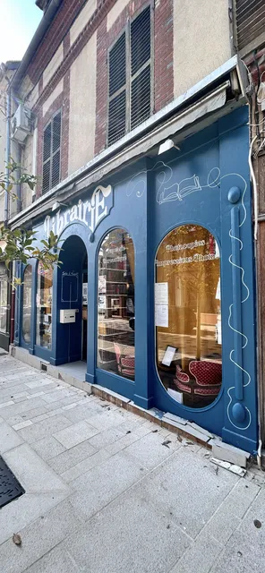 The painted blue storefront of the bookstore in France
