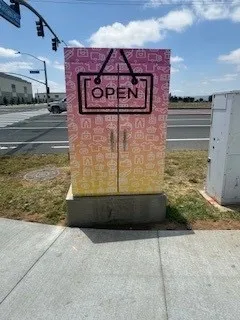 Moreno Valley utility box painted with an Open sign over a sunset
