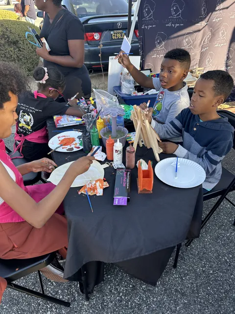 Kids painting together at a table outdoors