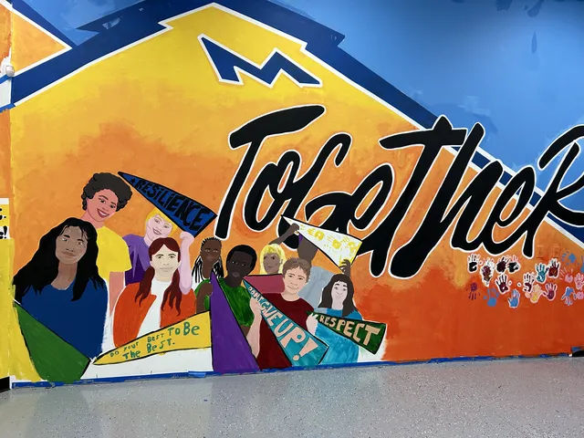 Bright Together mural with faces and color bands at the PAL Center