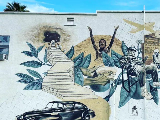 Close view of the Park Avenue mural with a raised hand and a classic car