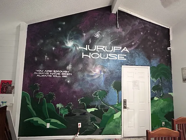 Galaxy mural wrapping a doorway, reading Jurupa House